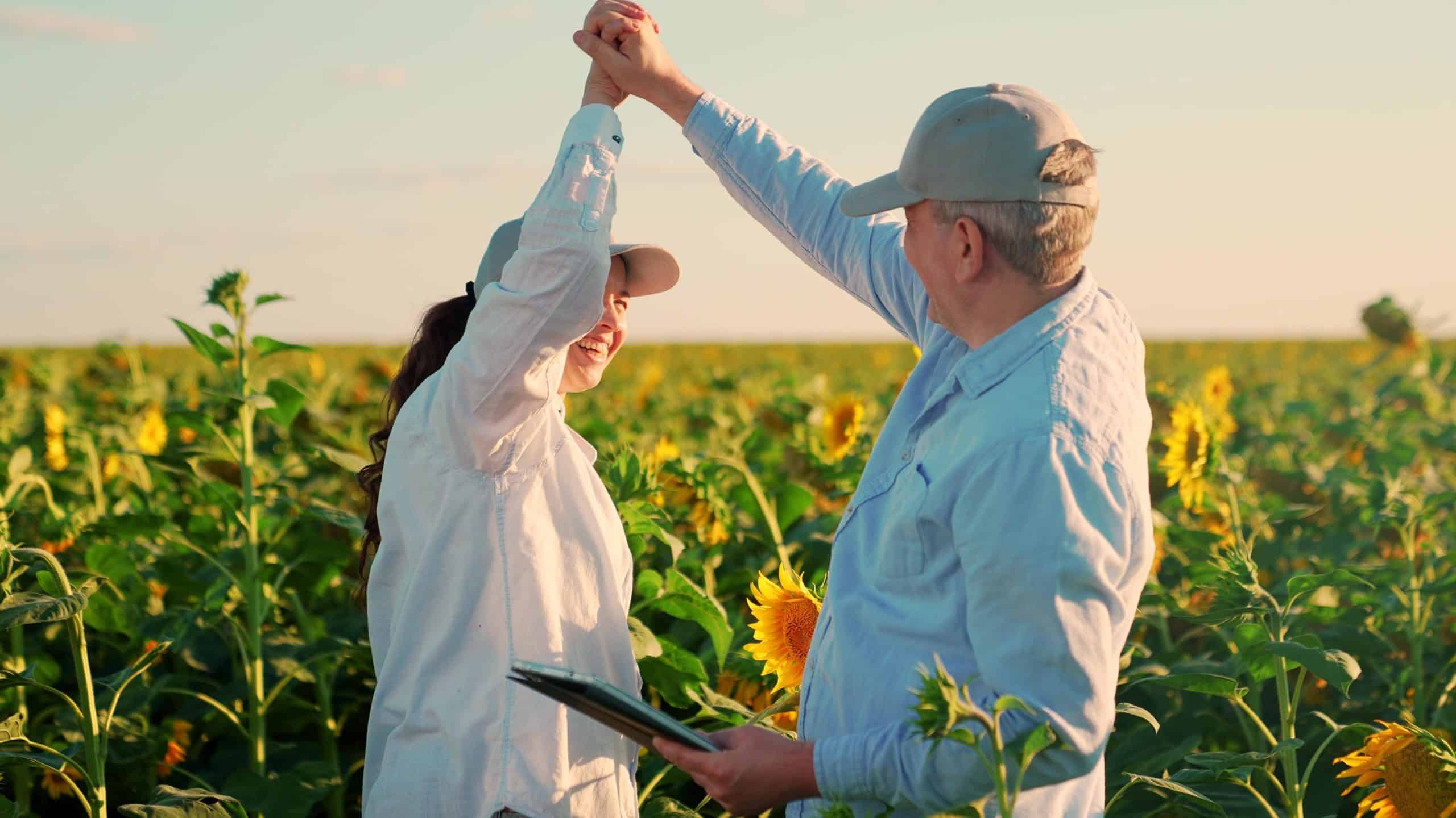 Female,Farmer,Shaking,Hands,With,Male,Farming,Partner,In,Field,